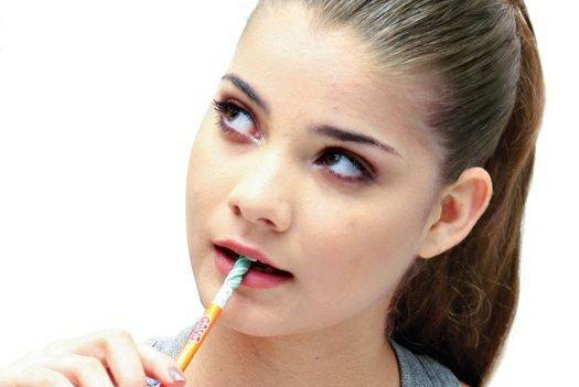 A girl with pencil in her mouth